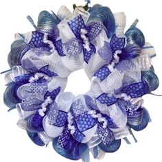 a blue and white mesh wreath hanging on the front door with an anchor in it