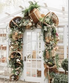 an arch made out of baskets and plants