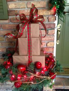 a stack of wrapped presents sitting on top of a christmas wreath