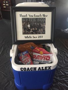 a blue and white cooler with some candy in it