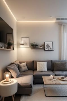 a living room filled with furniture next to a window covered in white curtained drapes