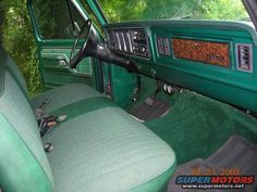 the interior of a green truck with leather seats and dash board on it's dashboard