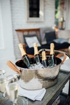 bottles of champagne in an ice bucket on a table