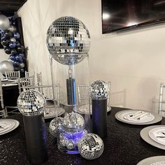 disco ball decorations and plates on a table