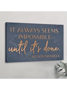 a blue and gold sign that says it always seems impossible until it's done