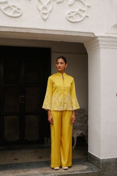 PRODUCT DETAIL: Discover a truly unique blend of structured elegance and fashionable comfort with our Yellow Embroidered Coat with Wide Pants. This ensemble redefines traditional and modern fashion, making it the perfect choice for upcoming festivities and formal occasions. The top, adorned with intricate embroidery, a Festive Fitted Palazzo Set With Embroidered Sleeves, Wedding Palazzo Set With Embroidered Sleeves For Eid, Traditional Palazzo Set With Embroidered Sleeves, Wedding Palazzo Set With Chikankari Embroidery, Chikankari Embroidery Palazzo Set For Wedding, Spring Festive Palazzo Set With Embroidered Sleeves, Embroidered Straight Palazzo Set For Festive Occasions, Festive Embroidered Straight Palazzo Set, Embroidered Festive Straight Palazzo Set