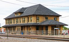 an old train station is shown on the tracks