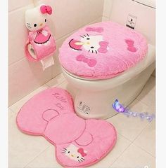 a pink hello kitty toilet seat cover and rug