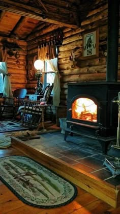 a wood burning stove sitting inside of a log cabin