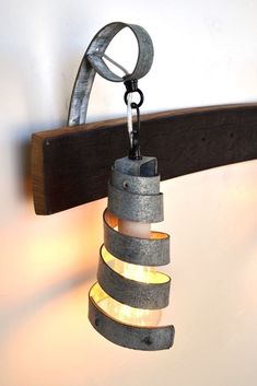 a light that is hanging from a hook with some lights on it's side