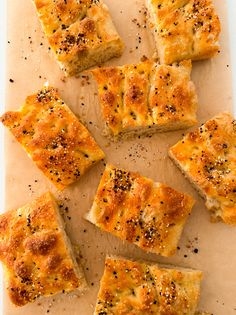 several square pieces of bread on a cutting board