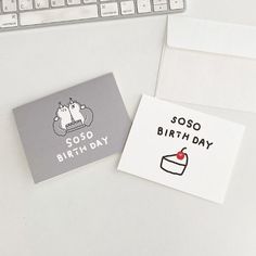 a birthday card and envelope sitting on top of a desk next to a computer keyboard