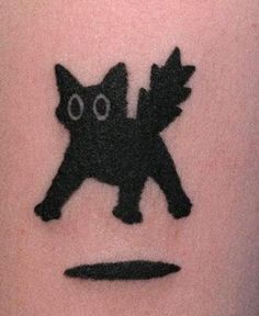 a black cat with big eyes on the arm