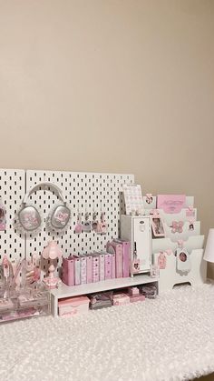 a white table topped with lots of pink items