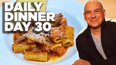 a man sitting in front of a plate of pasta with meat and sauce on it