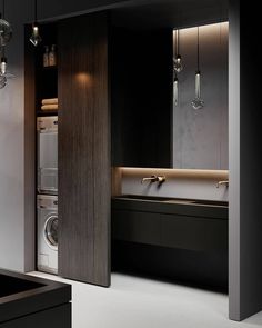 a washer and dryer in a room with dark wood paneling on the walls