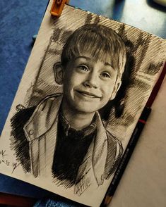 a pencil drawing of a young boy smiling