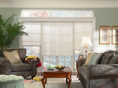 a living room with two couches and a coffee table in front of a window