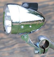 a close up of a bike handle with a mirror on it's headlight