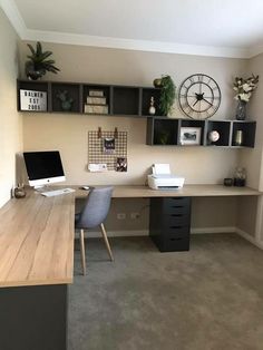 a home office with two desks and shelves on the wall