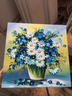 a painting of blue and white flowers in a vase