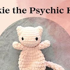 a white crocheted teddy bear sitting on top of a round object with the words, knit the psychic bear