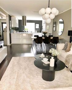 a living room filled with furniture and a white rug