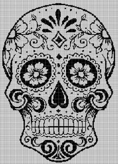 a black and white cross stitch skull with flowers on it's head, in the middle