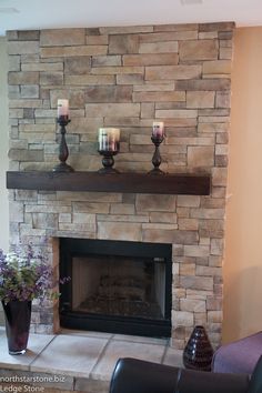 a living room with a fireplace and two candles