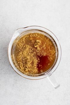 a blender filled with brown liquid on top of a white counter