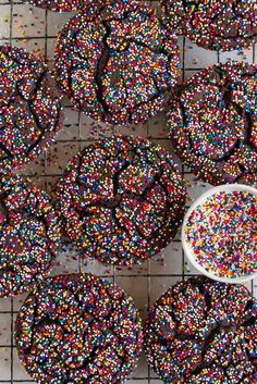 sprinkle covered cookies on a table with a spoon