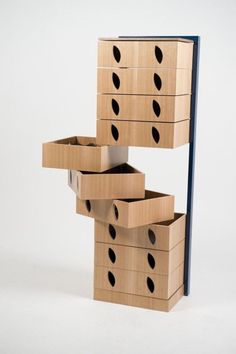 three wooden boxes stacked on top of each other with holes in the bottom and sides