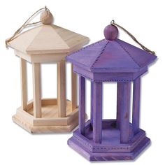 two purple and white wooden lanterns sitting next to each other