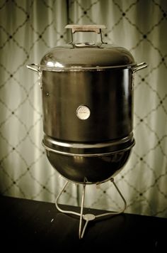 a large pot sitting on top of a metal stand