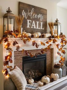 a fireplace decorated for fall with pumpkins and candles