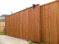 a large wooden fence in front of a house