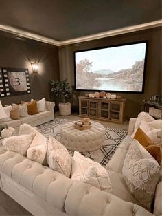 a living room filled with furniture and a flat screen tv mounted to the side of a wall