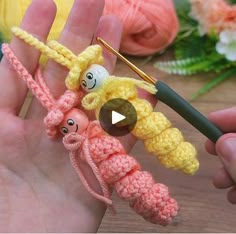 crocheted finger puppets being held by someone's hand