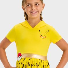 They're sure to love the fun style of this Pokemon Pikachu Cosplay Short-Sleeve Tutu Dress. Crafted from midweight jersey fabric with a hint of stretch, this hooded cosplay dress brings all-day comfort to their day. Designed in a yellow hue with a winking Pikachu graphic on the chest, a metallic golden band at the waist and a tulle skirt with an allover lightning bolt pattern, this dress offers a fan-favorite look. Best of all, the Pikachu ears on the hood lend an extra flair to the outfit.