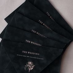 six black wedding envelopes with gold lettering