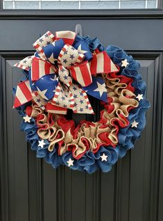 a patriotic wreath is hanging on the front door