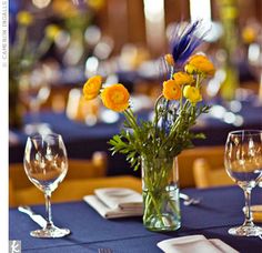 the table is set with flowers and wine glasses