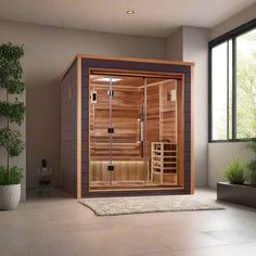 an indoor steam sauna is shown in the middle of a room with potted plants