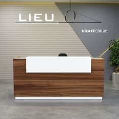 the reception desk is made of wood and white