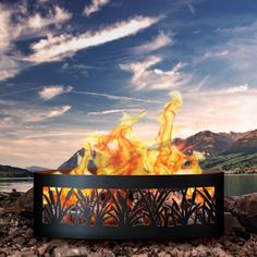 a fire pit sitting on top of a rocky beach