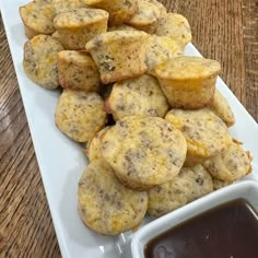 muffins on a white plate with dipping sauce