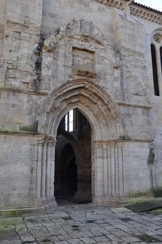 an old stone building with arched doorways