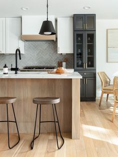 two stools are in front of the kitchen island