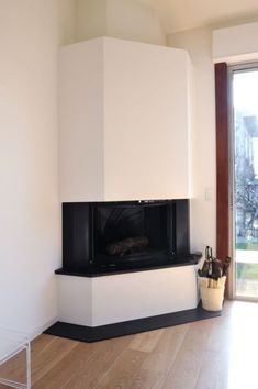 an empty living room with a fireplace and sliding glass doors