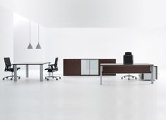 an empty office with two desks and chairs